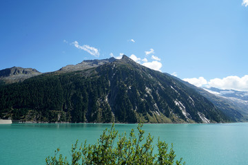 High situated reservoir in Austria with mountains in the background

