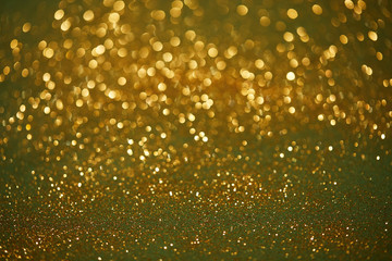 golden and green bokeh christmas background with shiny glitter