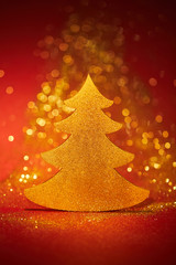 beautiful golden glittering christmas tree for decoration on red background