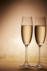 two glasses of champagne with glitter on tabletop, christmas concept