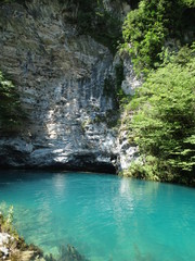 The blue lagoon in the mountains. Clean and fresh water in a deep lake. A beautiful mountain landscape for relaxation. Adventure in the mountains near the water
