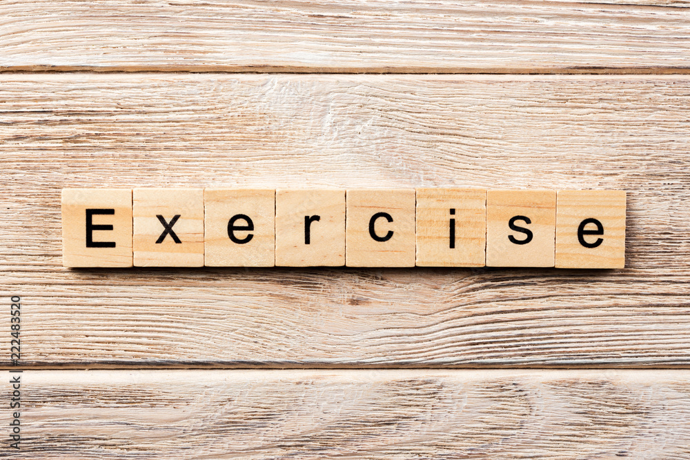 Fototapete exercise word written on wood block. exercise text on table, concept