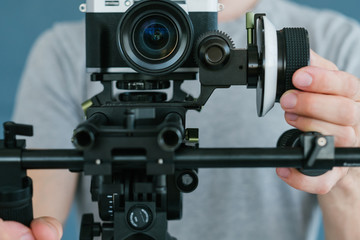 modern technology for video shooting.   man using camera holder for easy and comfortable footage creation. equipment and tools for blogging concept.