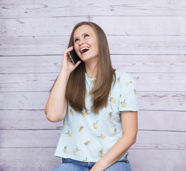 white girl with long hair talking on the phone and laughing, emotions