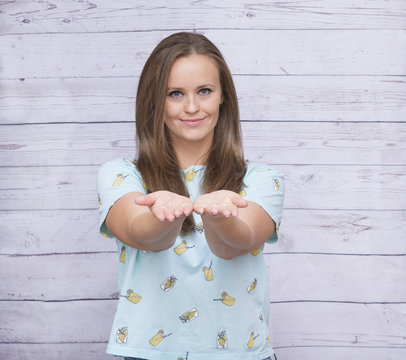 white girl with long hair in blue top with outstretched arms, young woman portrait