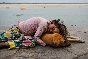 Love. Girl and dog. Varanasi city, India