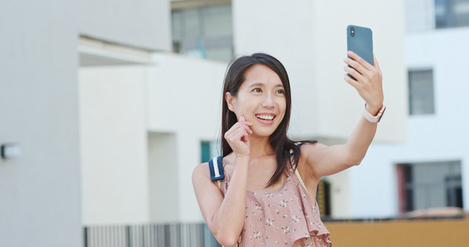 Woman taking vlog on cellphone in Shum Yip upperhills