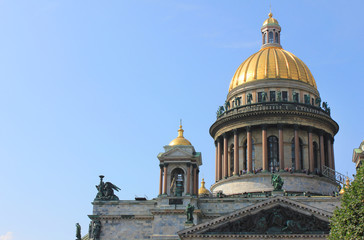 Fototapeta na wymiar Saint Isaac's Cathedral Facade, Colonnade, Dome and Columns Close Up View. Old Neoclassical Church Architecture Building, Close Up of Saint Isaac Cathedral Fronton and Golden Dome on Empty Blue Sky