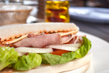 Sandwich with Ham and Cheese decorated lettuce, tomato, onion in the restaurant