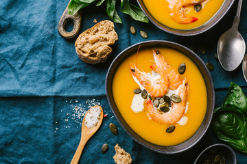 Autumn pumpkin creamy soup in bowls