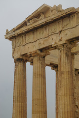 Athens, Greece: Detail of the Parthenon, 447-438 BCE, at the Acropolis of Athens, under a hazy sky caused by dust pollution.