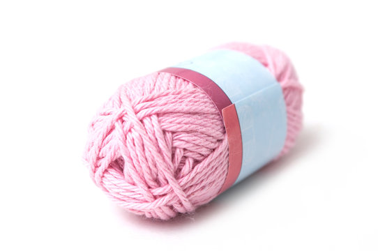 closeseup of pink wool bobin on white background