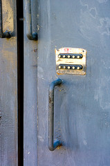 door lock for key closing, keyhole, hasp bolt. Collection of old vintage retro locks on the textured colored door. Close-up
