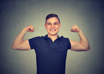 Fototapeta premium Strong young man showing biceps