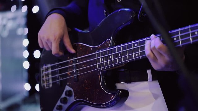 Man Playing on Bass Electric Guitar