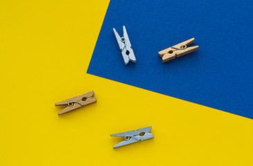 Small clothespins on a yellow blue background