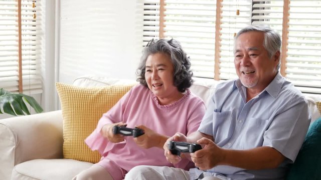 Senior man and woman playing game together at home with happy emotion. People with happy, lifestyle, entertainment concept. 4k resolution.