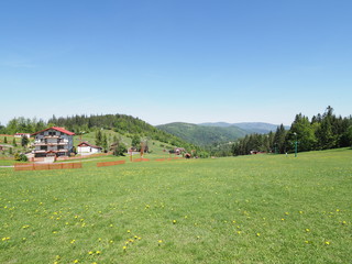 Fototapeta premium Calm housing estate and countryside landscape at Beskid Mountains range at european Salmopol village in Poland