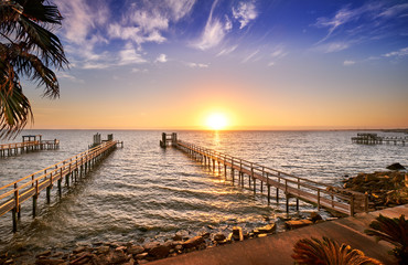 Long wooden fishing docks stretch out into Galveston Bay, Texas - Powered by Adobe