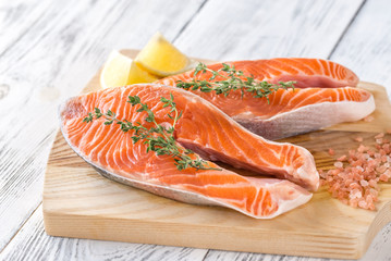 Raw trout steaks on the wooden board