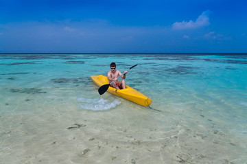 Maldives,  man in canoe