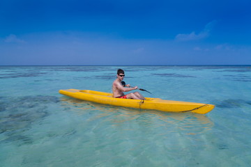 Fototapeta na wymiar Maldives, man in canoe