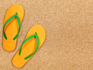 Fototapeta na wymiar Yellow rubber sandals flip flops on wooden background