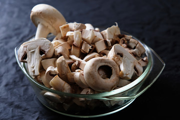 mushrooms champignons on a dark background