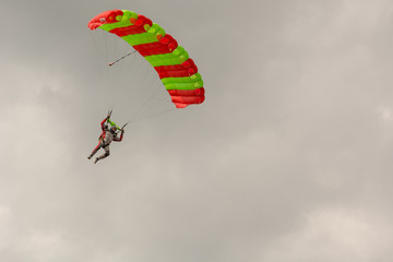 The parachutist flies. The paratrooper is in the air. Parachute flight.