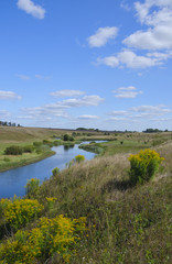 Fototapeta na wymiar Sunny summer landscape with river,fields,green hills and beautiful clouds in blue sky.River Upa in Tula region,Russia. 