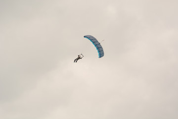 The parachutist flies. The paratrooper is in the air. Parachute flight.