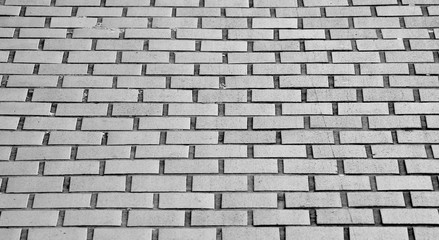 patterned paving tiles, ceramic brick floor background - monochrome