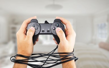 Wired hands with joypad meaning videogame addiction