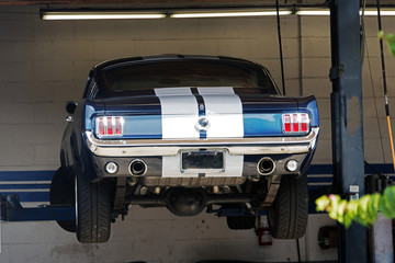 A vintage classic American car on the lift in a repair shop in Venice beach, California