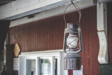 Old oil lamp hanging on a porch outside