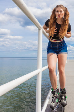 Joyful teen girl wearing roller skates