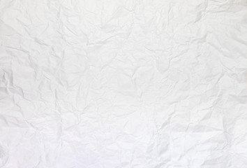 Background or pattern of Wrinkled white rectangular paper with rough texture.