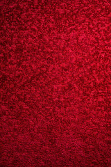Texture of a dark red carpet. Close-up of gradient light