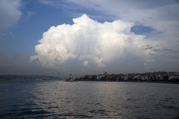 Naklejka na ściany i meble The Istanbul Bosphorus and beautiful cumulus cloud with reflections and The Maiden's Tower 