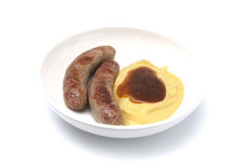 Bangers and Mash or Sausage and Mashed Potatoes in a White Plate