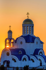 village church on a meadow in the evening