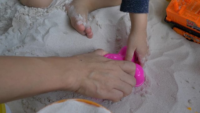 slow motion, mother using toy block sand shape with cute child have fun