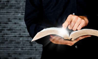 Young man hands holding open book