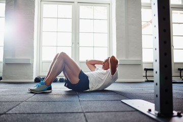 Senior man doing an ab workout in a gym