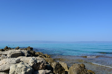 Afytos beach in Greece, rocks and blue sea