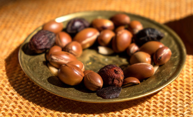 Argan nuts seeds on a plate - Argan is useful as antioxidant for healing redness inflammations skin stretch marks