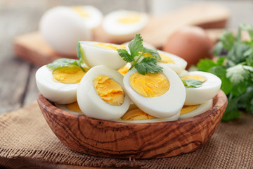 Sliced boiled eggs,decorated with parsley leaves.