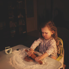 Fototapeta na wymiar Little girl cooking Christmas cookies.