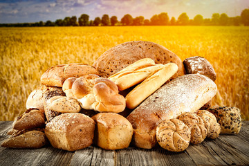 Fresh fragrant bread on a wooden table in a beautiful golden cereal     