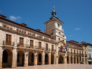 Fototapeta na wymiar Townhall of Oviedo in early morning light with blue sky, Spain